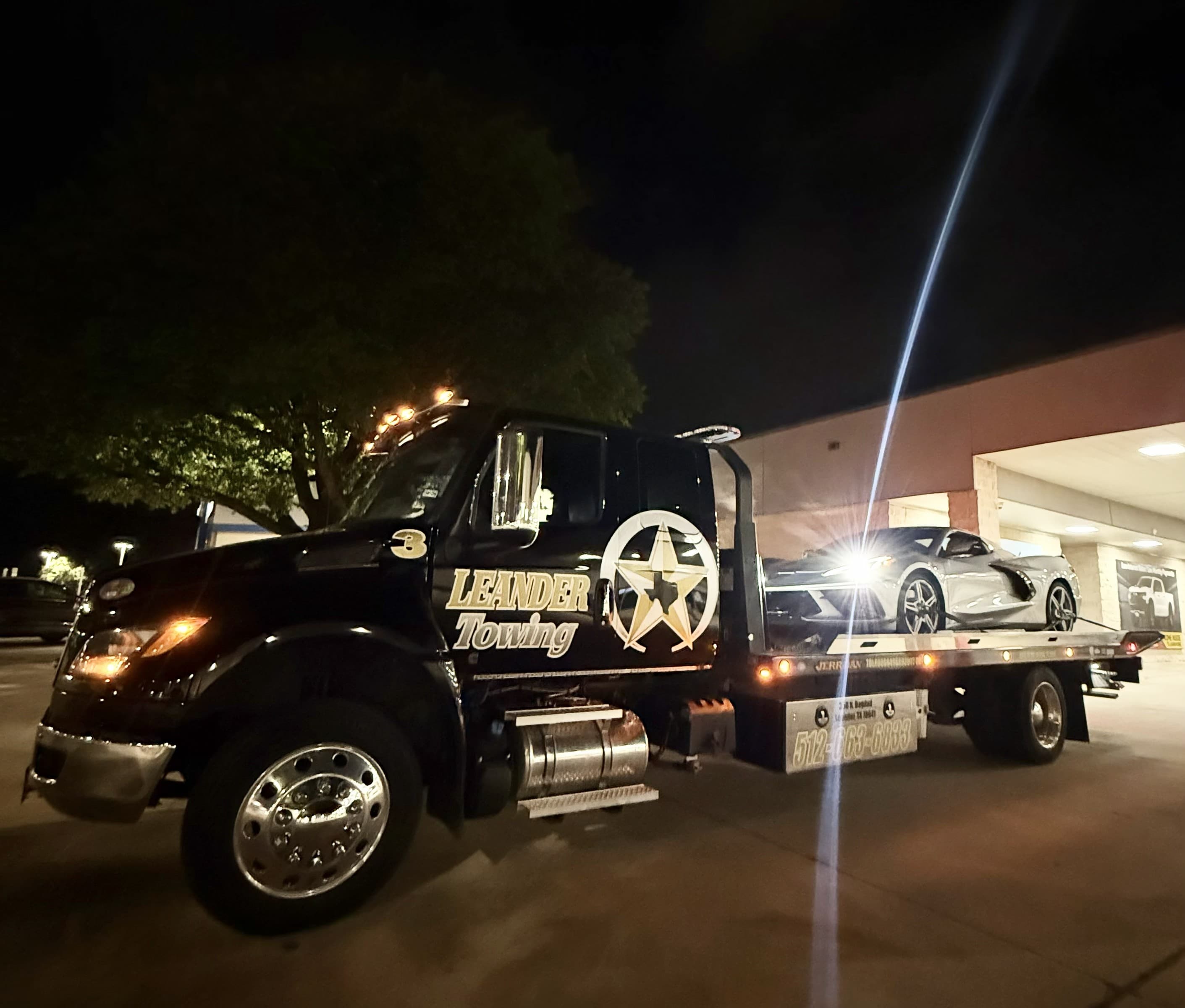 Leander Towing flatbed carrying a classic car